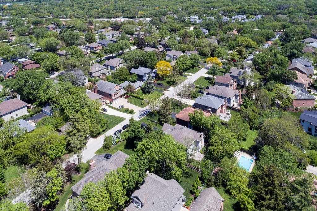 Aerial view of a neighborhood with mature trees in a Chicago sub